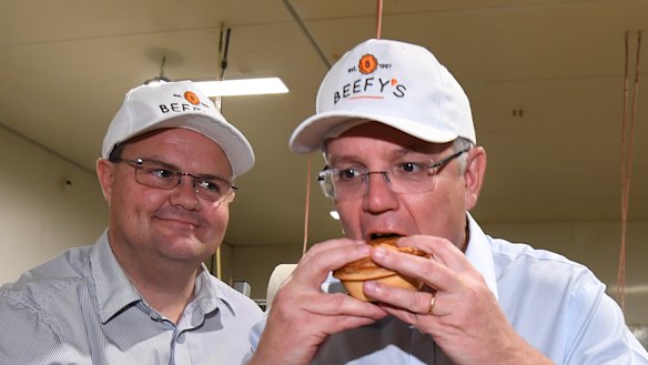 Scott Morrison eats a pie during a visit to the Beefy's Pies factory near Maroochydore.