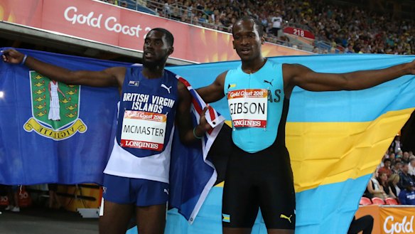 Kyron Mcmaster of the British Virgin Islands, left, and the Bahamas' Jeffery Gibson celebrate their gold and silver medals in the men's 400m hurdles final.