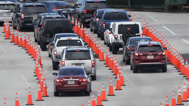 Lines of cars wait to be checked in at a COVID-19 testing site outside Hard Rock Stadium in Miami Gardens, Florida. 