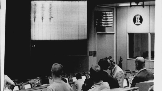 Controllers in mission control watch the seismograph readings from the Apollo 13.