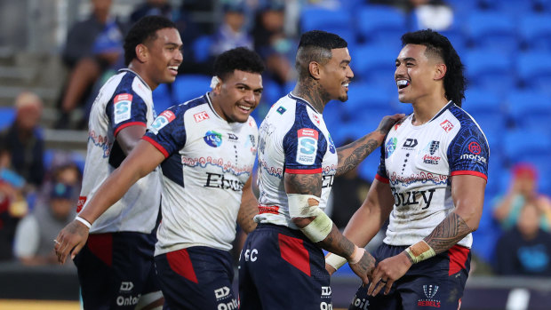 David Feliuai (right) celebrates with Rebels teammates.