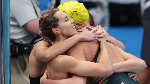 Emma McKeon hugs her teammates after the 4x200m freestyle relay.