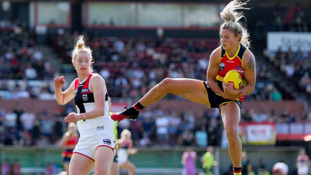 Fend off: Anne Hatchard of the Crows marks while keeping St Kilda's Kate Shierlaw out of the contest.