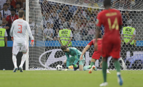 Oops: Spain's David De Gea lets Cristiano Ronaldo's ball slip through his fingers in Sochi.