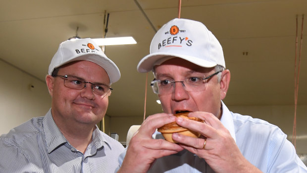 Scott Morrison eats a pie during a visit to the Beefy's Pies factory near Maroochydore.
