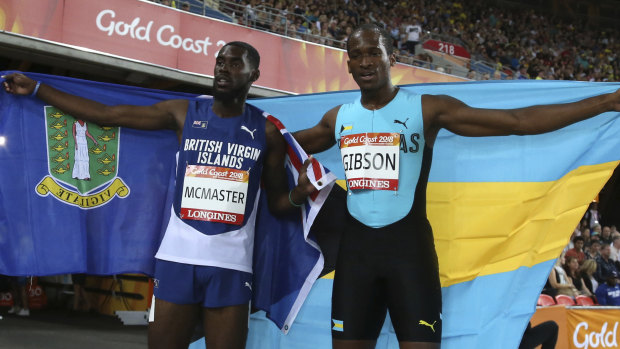 Kyron Mcmaster of the British Virgin Islands, left, and the Bahamas' Jeffery Gibson celebrate their gold and silver medals in the men's 400m hurdles final.