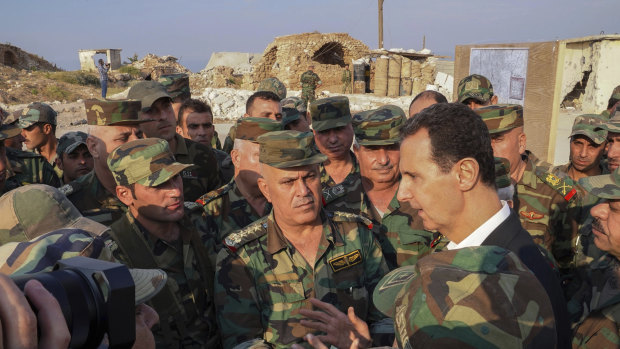 Syria's President Bashar al-Assad speaks with his troops in Habeet int he province of Idlib.