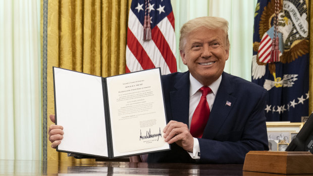 President Donald Trump smiles after signing a full pardon for a non-violent drug offence last year. 