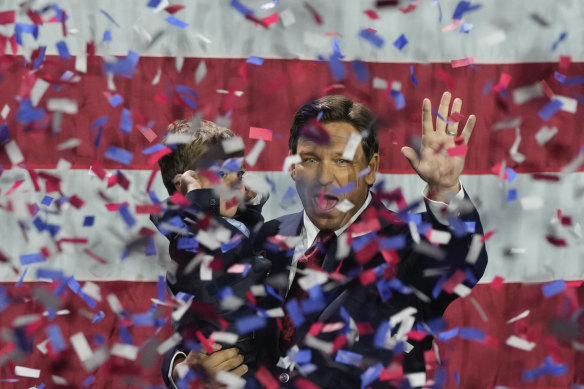 Incumbent Florida Republican Governor Ron DeSantis holds his son Mason as he celebrates winning reelection, at an election night party in Tampa, Florida, November 8, 2022.