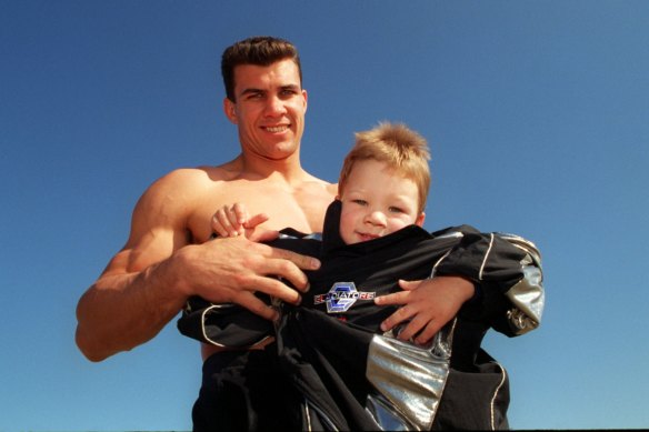 Mark McGaw with his son, Torey, in his gear from Seven show Gladiators.