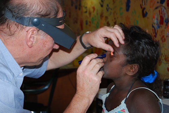 Hugh Taylor examining a child for trachoma, circa 2016.