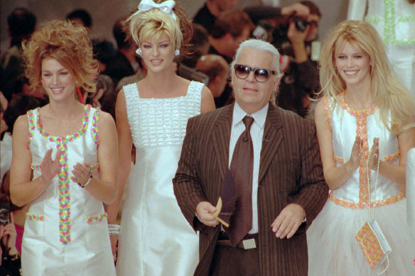 Karl Lagerfeld with models Cindy Crawford, Linda Evangelista and Claudia Schiffer after his spring-summer show for Chanel in Paris, 1995.
