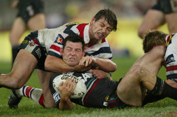 Craig Gower is tackled by Luke Ricketson in the 2003 grand final.