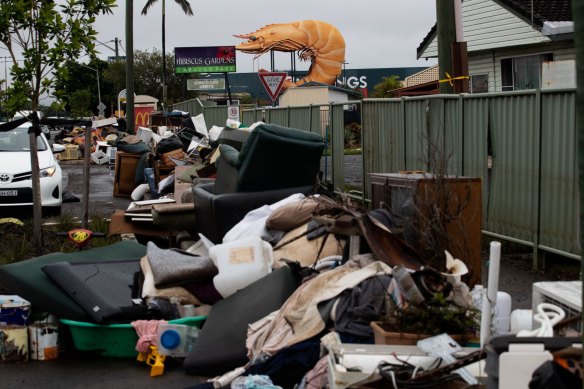 Like middens of loss: Streets in Ballina lined with flood damaged possessions on March 8.