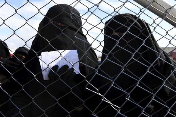 Foreign ISIS wives and children at the fenceline of the foreign section of Al Hawl camp in Al Hawl. 