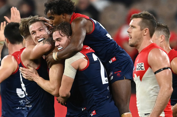 Melbourne has won its first eight games for the first time since 1965 after holding off the Swans.