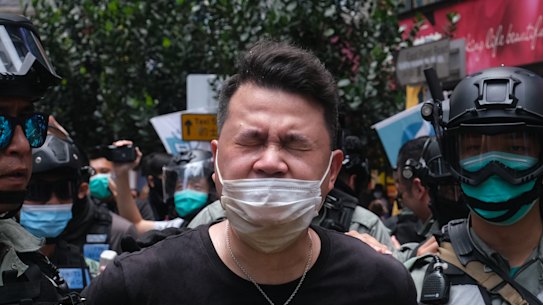 Andrew Wan, a pro-democracy legislator, is arrested by riot police during a protest in Hong Kong on Wednesday.