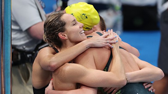 Emma McKeon hugs her teammates after the 4x200m freestyle relay.