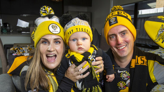 Richmond Tigers fans Amy and Clinton Brown with their son Law are looking forward to the footy.
