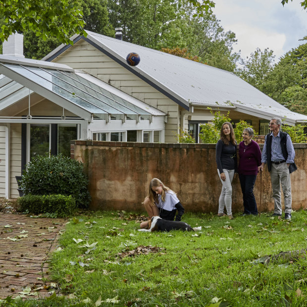 Happy home: children Manning and Audrey with mother Zoe Flanagan-Field, Zoe’s parents, Robin and Warwick Mosman, and father Craig Field, outside the home they share in the Blue Mountains.