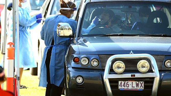 Residents are tested for COVID-19 at a pop-up clinic at Indooroopilly State High School, the centre of the state’s latest outbreak and within an area boasting one of the highest vaccination rates in the country.