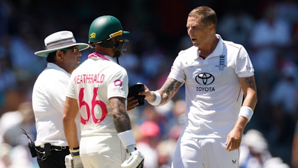 Brydon Carse and Jake Weatherald exchange words.