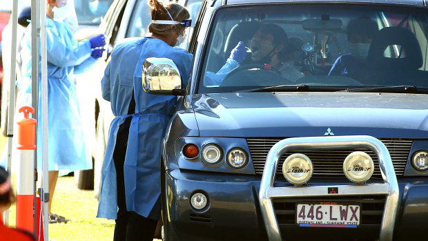 Residents are tested for COVID-19 at a pop-up clinic at Indooroopilly State High School, the centre of the state’s latest outbreak and within an area boasting one of the highest vaccination rates in the country.