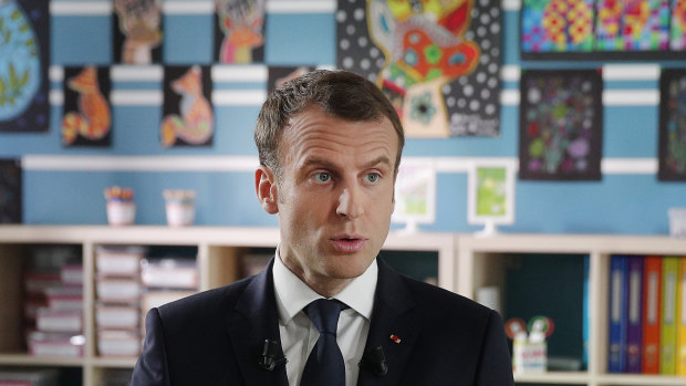 French president Emmanuel Macron in a classroom. 