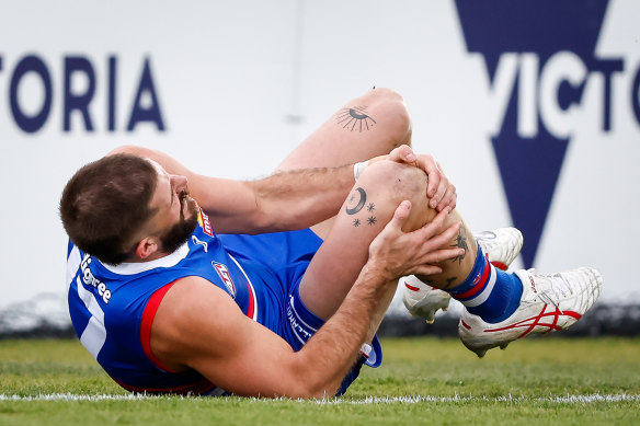 Bulldog Josh Bruce holds his knee before being helped off the ground.
