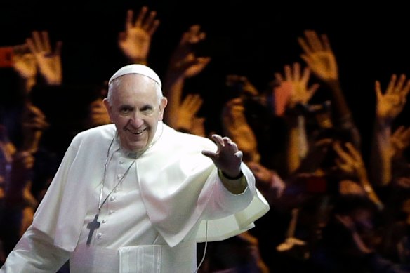 Pope Francis waves to the crowd during a parade in Philadelphia in 2015.