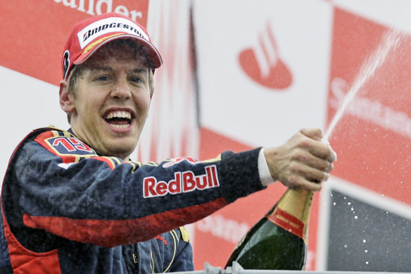 Sebastian Vettel celebrates on the podium after taking his Toro Rosso to victory during the Formula One Grand Prix in Monza, Italy in 2008.