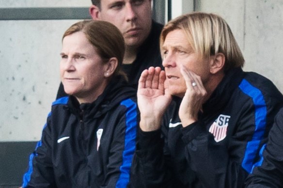 Tony Gustavsson in the dugout with USA coach Jill Ellis.