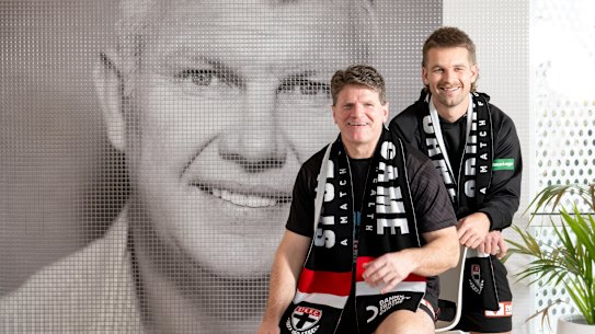 Never forgotten: St Kilda legend Robert Harvey and current player Dan Butler pose in front of a mural of Danny Frawley ahead of “Spud’s Game”.