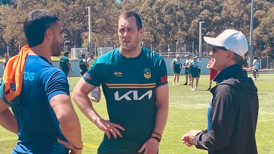 Wallaby Tom Wright (left), Isaah Yeo (centre) and Les Kiss chat after the Kangaroos trained on Monday.