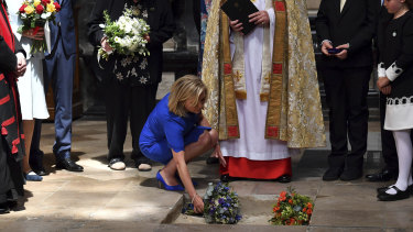 Lucy Hawking lays flowers as the ashes of her father, Professor Stephen Hawking, are laid to rest among Britain's greatest scientists in Westminster Abbey. 