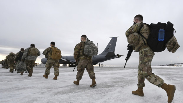 Airmen and soldiers from the Alaska National Guard prepare to depart from Joint Base Elmendorf-Richardson on Sunday to assist with Joe Biden's inauguration.