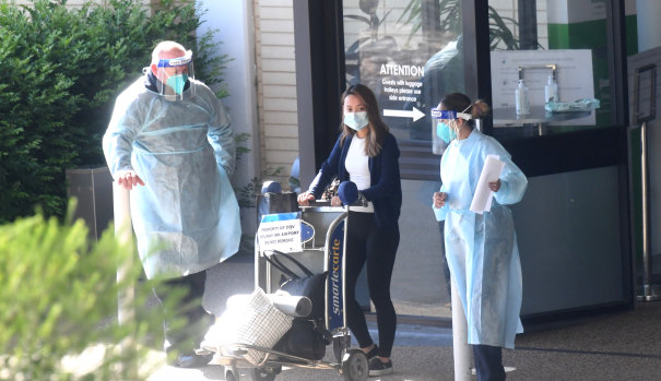 A guest is evacuated from the Holiday Inn quarantine hotel on Wednesday morning. 