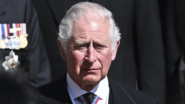 Prince Charles sheds a tear as he follows the coffin at Windsor Castle.