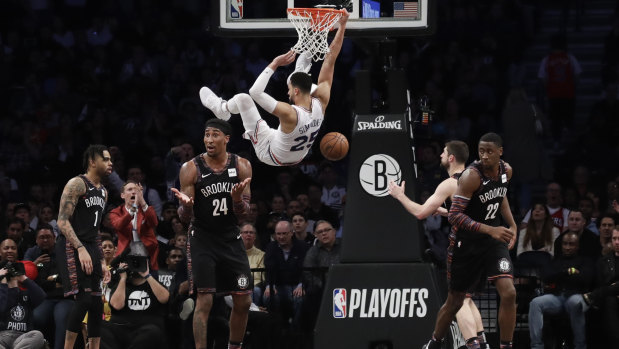 Brooklyn Nets' Rondae Hollis-Jefferson (24), Caris LeVert (22) and D'Angelo Russell (1) react to a dunk by Philadelphia 76ers' Ben Simmons (25) during the second half in Game 3 of a first-round NBA basketball playoff series in New York.
