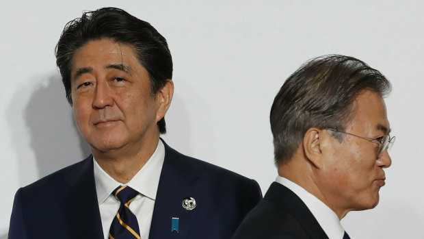 Japanese PM Shinzo Abe, left, and South Korean President Moon Jae-in.