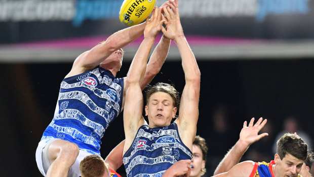 Rhys Stanley (centre) of the Cats in a contest for the ball.