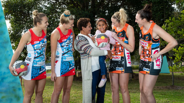 Fashion statement: Marcia Ella-Duncan and her granddaughter Gianna with Swifts Paige Hadley and Maddy Turner, left, and Giants    Jo Harten and Sam Poolman at the launch of their Indigenous round uniforms.

 