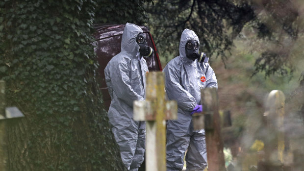 Forensic officers work at the London Road cemetery in Salisbury, England, following the poisoning of Sergei and Yulia Skripal in March.