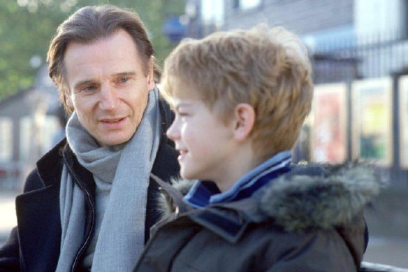 A young Thomas Brodie-Sangster in Love Actually with Liam Neeson, who played his stepfather.