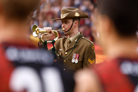 The Last Post is played on Anzac Day before the Essendon vs Collingwood clash at the MCG.