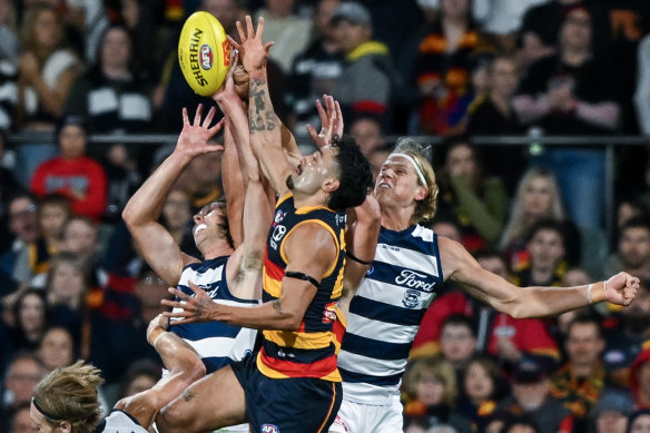 Izak Rankine of the Crows high in the pack over Tom Stewart of the Cats