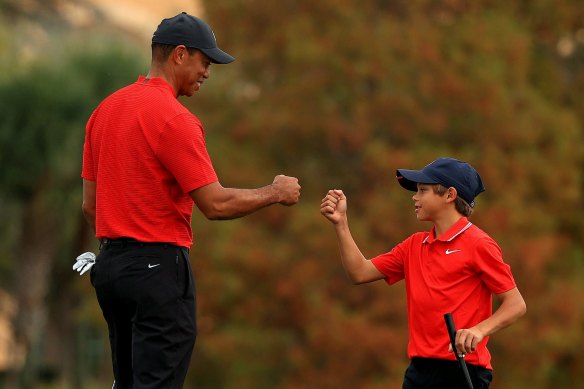 Woods and Charlie celebrate on the 18th.