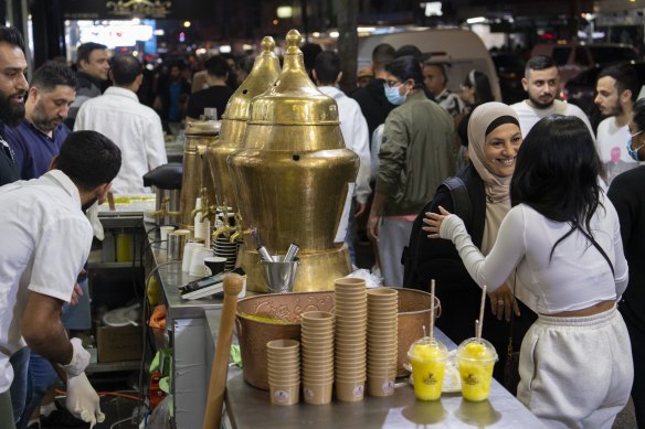 Women chat at a drink stall in Haldon Street.