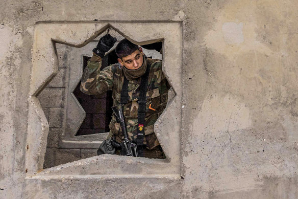 At an urban warfare training facility in the Negev Desert, an Israeli soldier takes part in a drill in January.