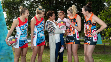 Fashion statement: Marcia Ella-Duncan and her granddaughter Gianna with Swifts Paige Hadley and Maddy Turner, left, and Giants    Jo Harten and Sam Poolman at the launch of their Indigenous round uniforms.   